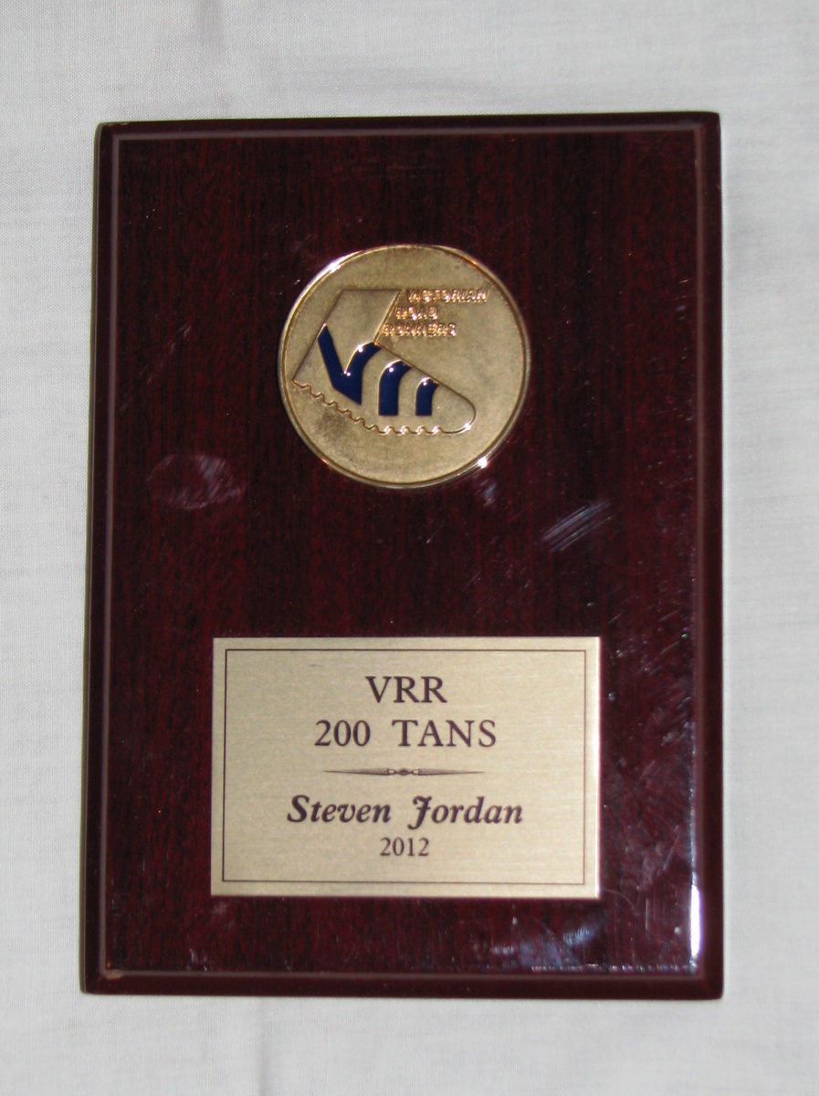 Steve Jordan Remembrance
When Steve Jordan (C58) died in late 2014, we were lucky enough to get this keep sake for our club records. As Steve was an avid fun runner, it was perhaps fitting that the shield we have was awarded to him in 2012 to recognise his feat in completing his 200th monthly Tan run with the Victorian Road Runners.

