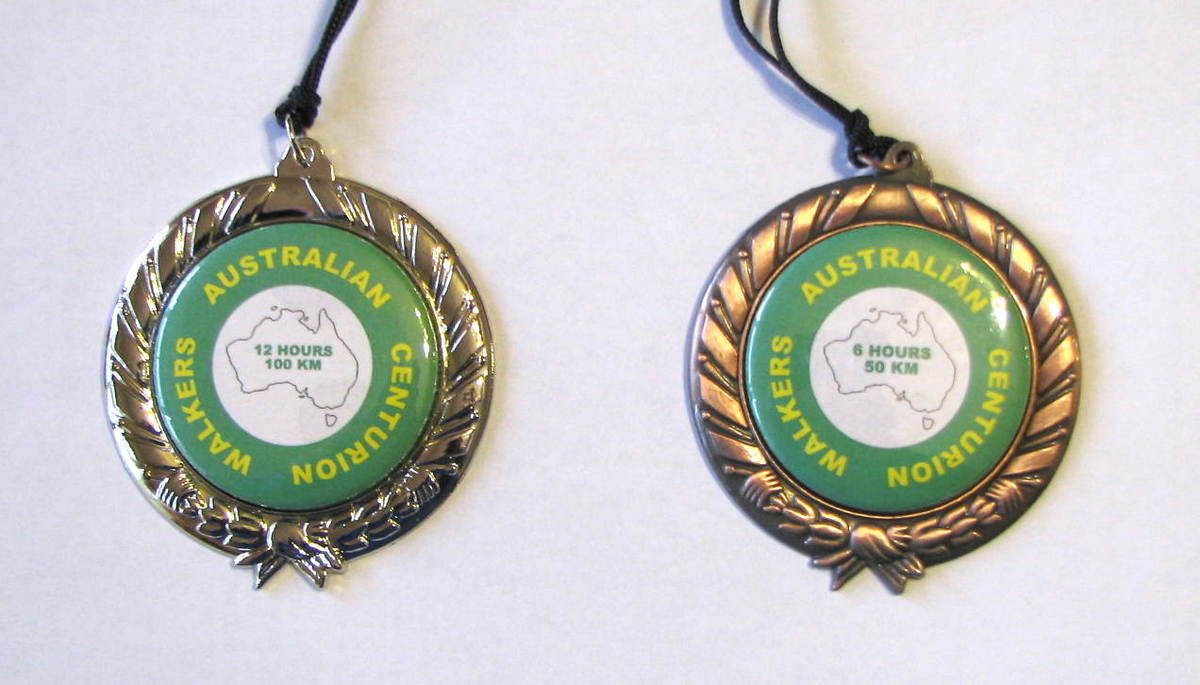 The Centurion Silver and Bronze Medals
Those walkers who complete 100 miles in our centurion qualifying event are awarded an Australian Centurion badge. For their first successful completion, the badge is numbered. For subsequent centurion efforts, they receive an unnumbered badge. Each Centurion club around the work has its own unique badge and many walkers try to collect as many as they can - but it is not an easy ask!

