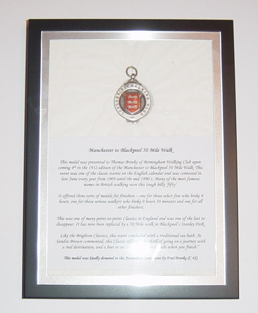 1932 Manchester to Blackpool 50 Mile Walk
This medal was presented to Thomas Brooks of Birmingham Walking Club upon coming 4th in the 1932 edition of the Manchester to Blackpool 50 Mile Walk. This event was one of the classic events on the English calendar and was contested in late June every year from 1909 until the mid 1990's. It offered three medals: one for those select few who broke 8 hours, one for those serious walkers who broke 9 hours 30 minutes and one for all other finishers. This medal was kin
